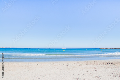 View from the beach to the sea, port, ships, yachts. © Iryna