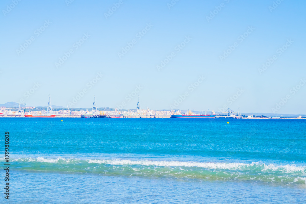 View from the beach to the sea, port, ships, yachts.