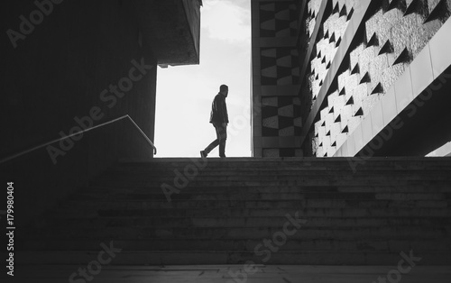 silhouette of a walking man in a city. black and white photo