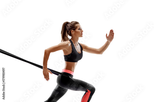 Woman exercising fitness resistance bands in studio silhouette isolated on white background photo