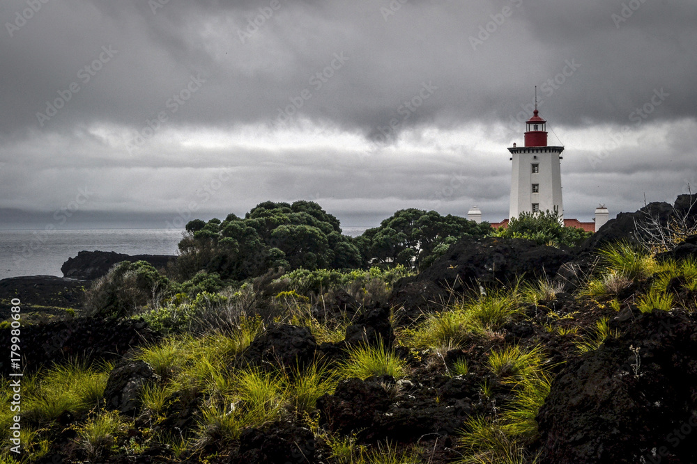 white-red beacon at the end of the lagoon coast of Pico Island in the Azores