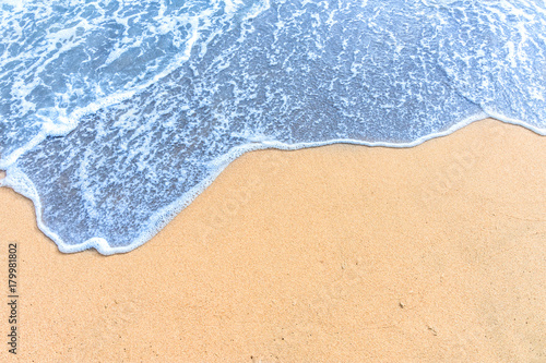 Soft wave with blue ocean on sandy beach. © Pataradon