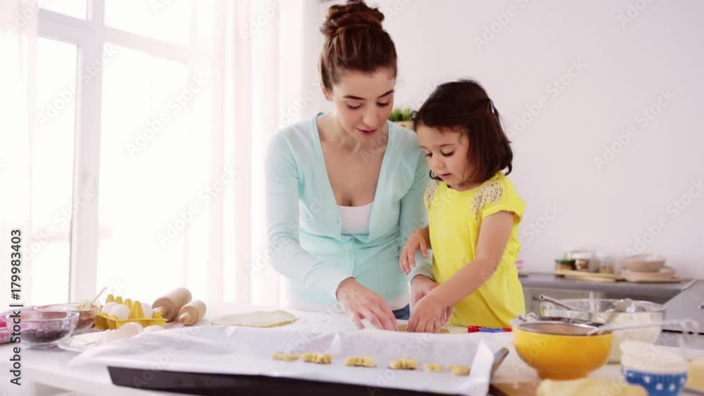 happy mother and daughter making cookies at home happy mother and daughter making cookies at home