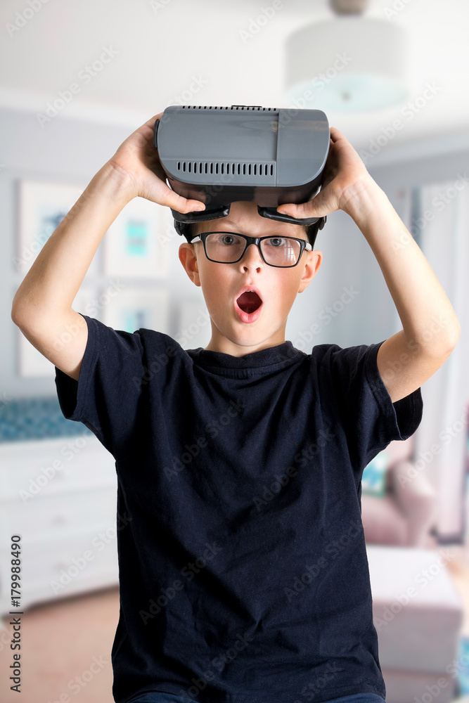 young kid child play VR virtual reality game googles in room exciting new computer smartphone young kid child play VR virtual reality game googles in room exciting new computer smartphone