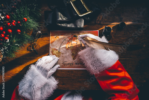 High angle view of Santa Claus making gifts for Christmas photo