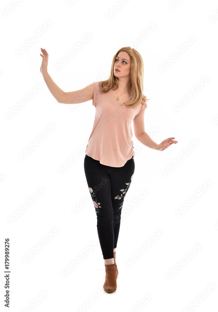 full length portrait of a girl wearing pink shirt and black floral pants. standing pose, isolated on white background. full length portrait of a girl wearing pink shirt and black floral pants. standing pose, isolated on white background.