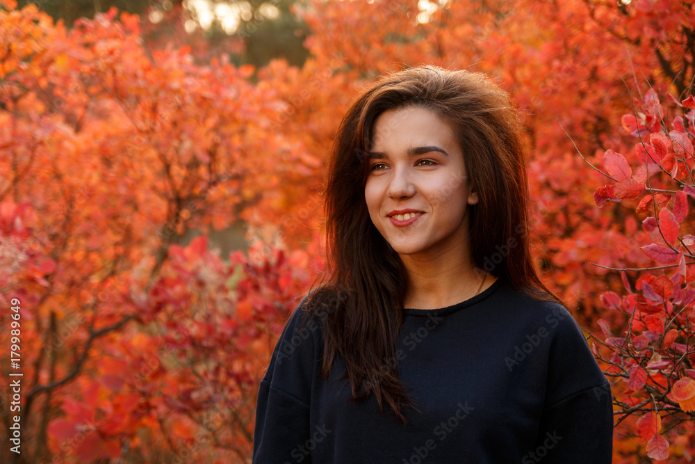 Young girl standing in autumn wood in sportswear Young girl standing in autumn wood in sportswear