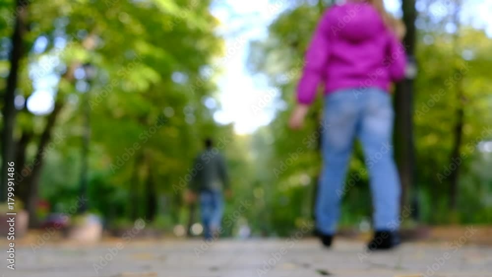 People walking at the autumn park alley. Blurred background People walking at the autumn park alley. Blurred background