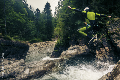 Germany, Bavaria, Allgaeu, young man canyoning in Ostertal