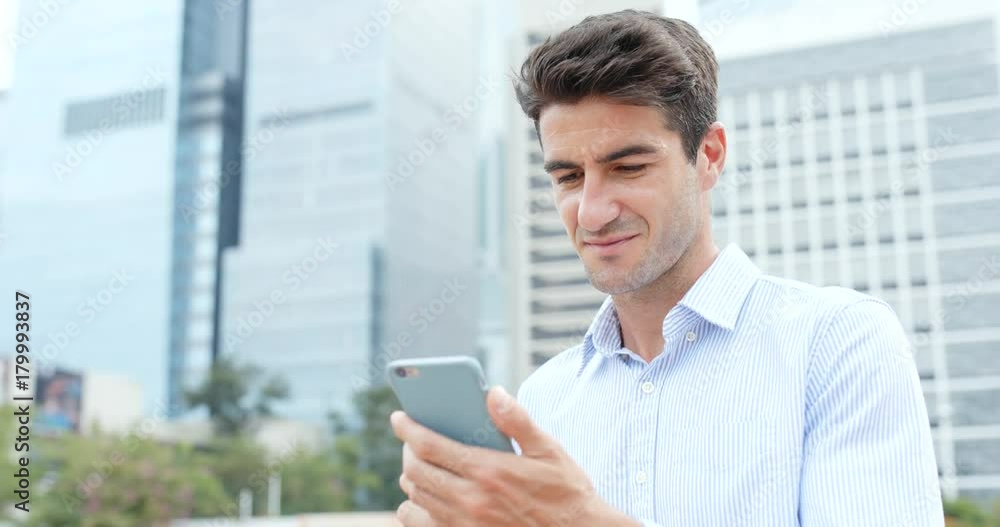 Hispanic businessman use of mobile phone Hispanic businessman use of mobile phone