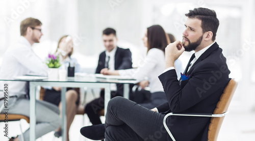  Manager of the company on the background of the working meeting the business team