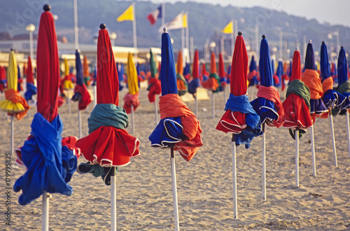 Early morning sun umbrellas on the beach at Deauville