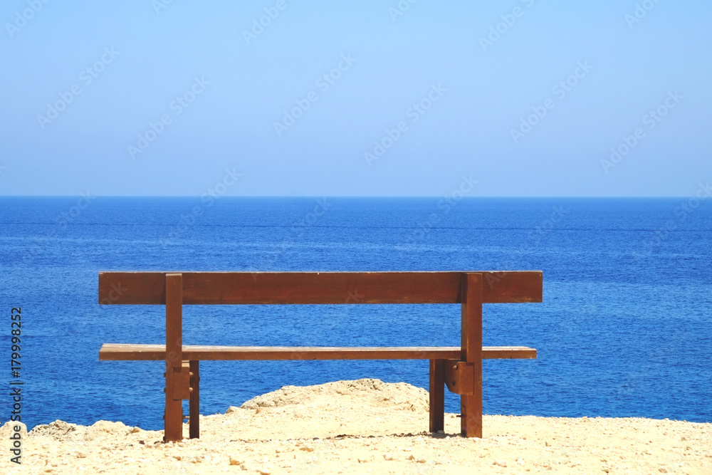 Empty bench facing the sea ocean