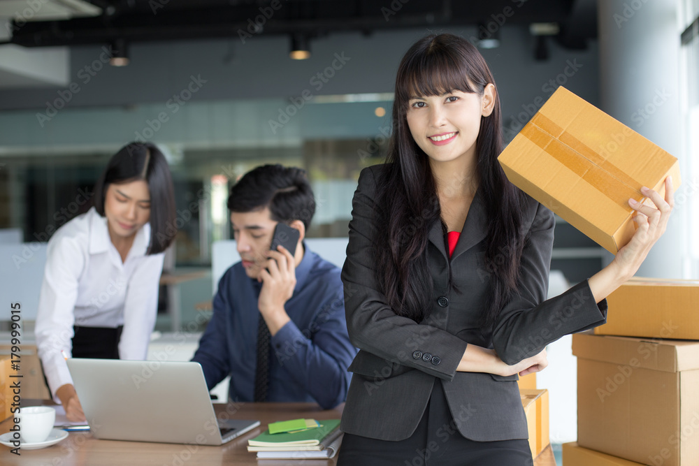 Young Asian Woman holding box with smiling together, Young Owner Woman Start up for Business Online, SME, Delivery Project, Woman with Online Business or SME Concept. Young Asian Woman holding box with smiling together, Young Owner Woman Start up for Business Online, SME, Delivery Project, Woman with Online Business or SME Concept.