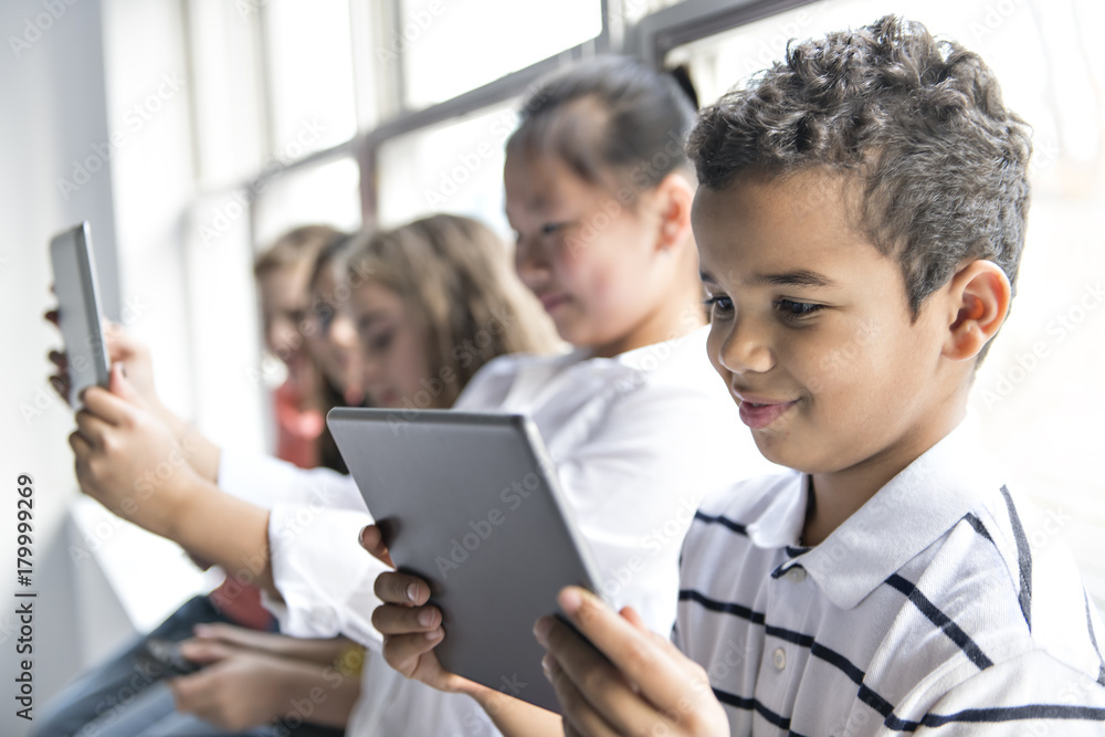 Group of curious children watching stuff on the tablet screen Group of curious children watching stuff on the tablet screen