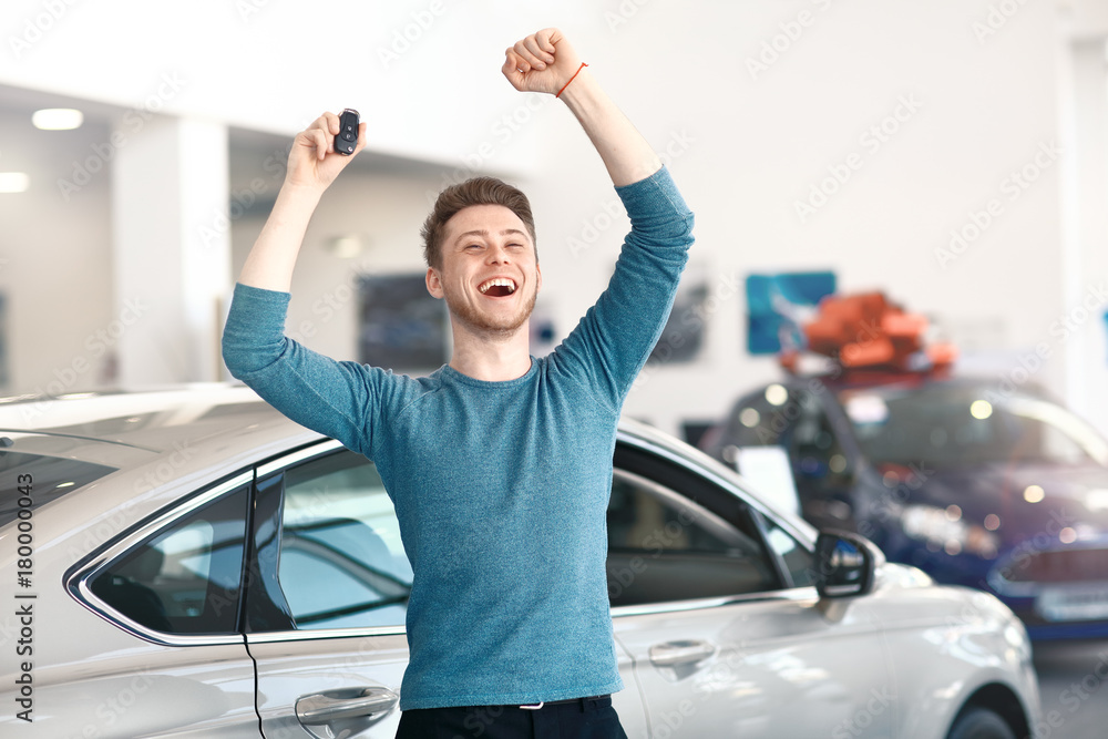 Foto de Lucky winner in car dealership. do Stock Adobe Stock
