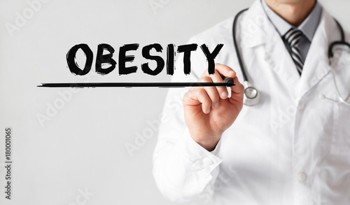 Doctor writing word OBESITY with marker, Medical concept