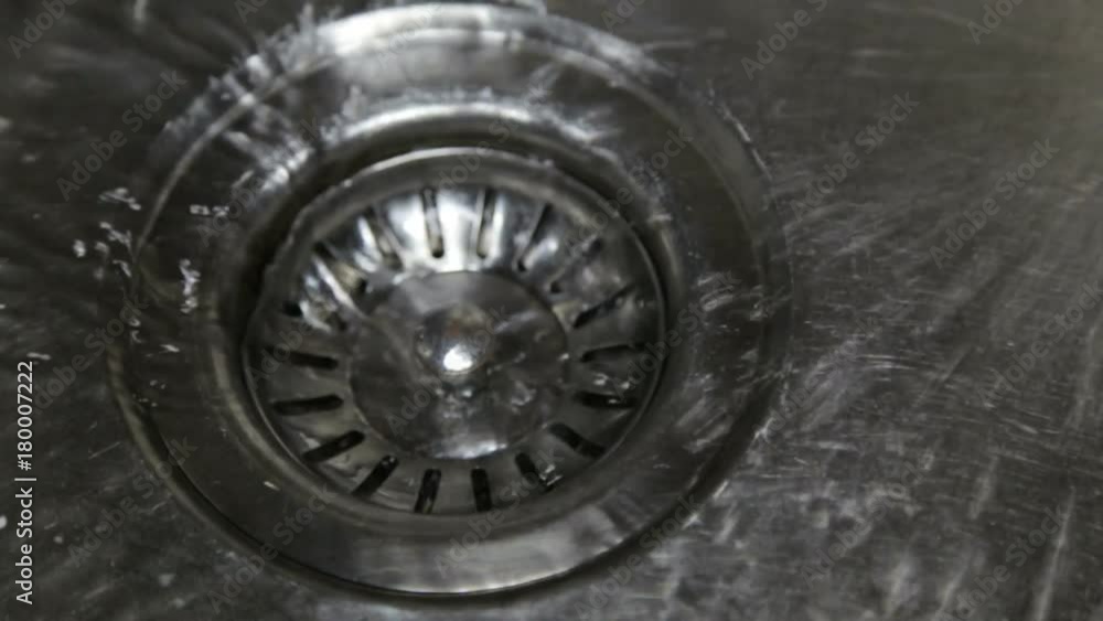 Drain water in a stainless sink in the kitchen Drain water in a stainless sink in the kitchen