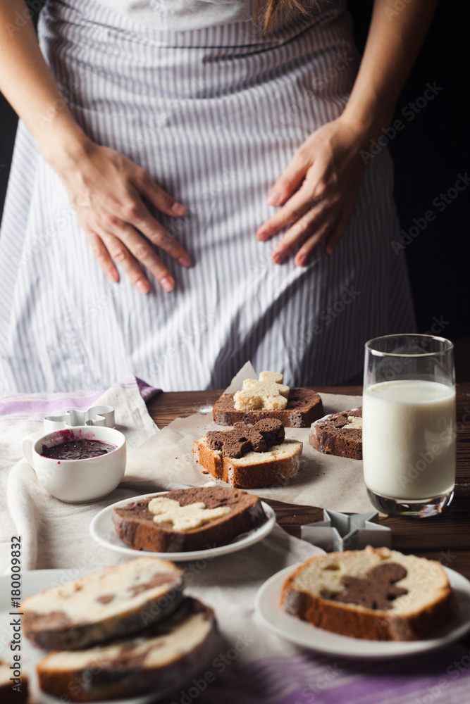 Woman's arms slicing cake on table in morning Woman's arms slicing cake on table in morning