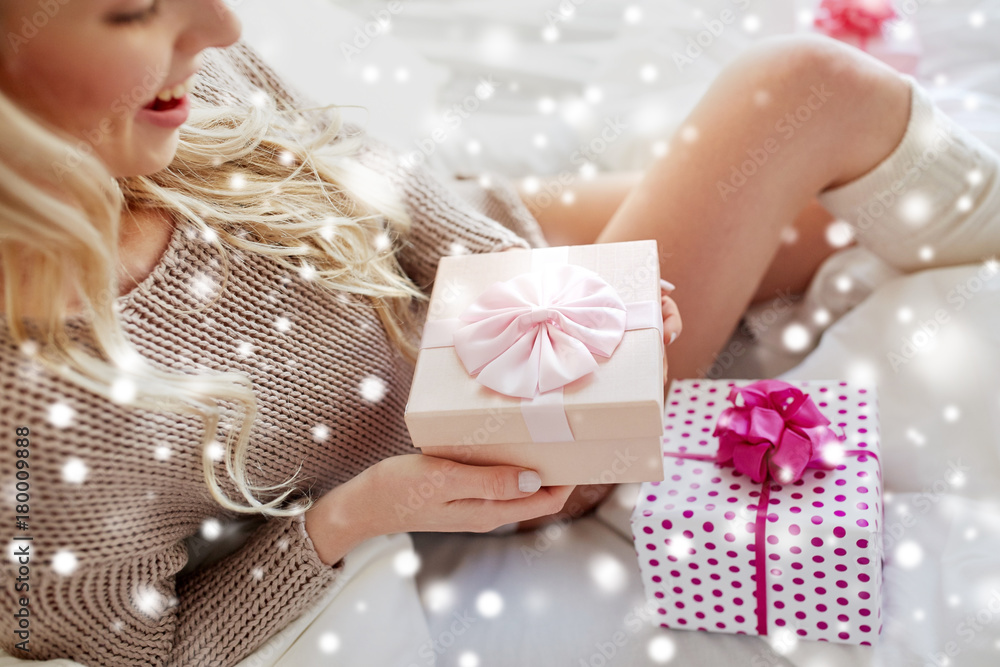 close up of happy woman with christmas gift in bed close up of happy woman with christmas gift in bed