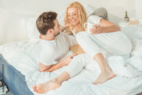 couple drinking coffee in bed