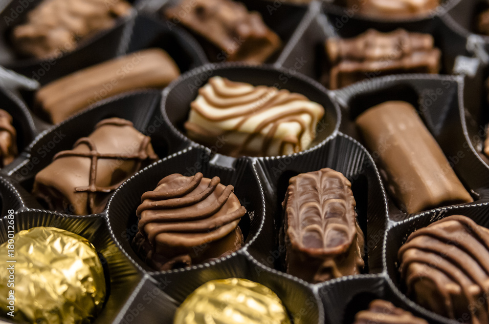 Chocolate candy in the box. Chocolate sweets. An assortment of fine chocolates in white, dark, and milk chocolate. Chocolate candy in the box. Chocolate sweets. An assortment of fine chocolates in white, dark, and milk chocolate.