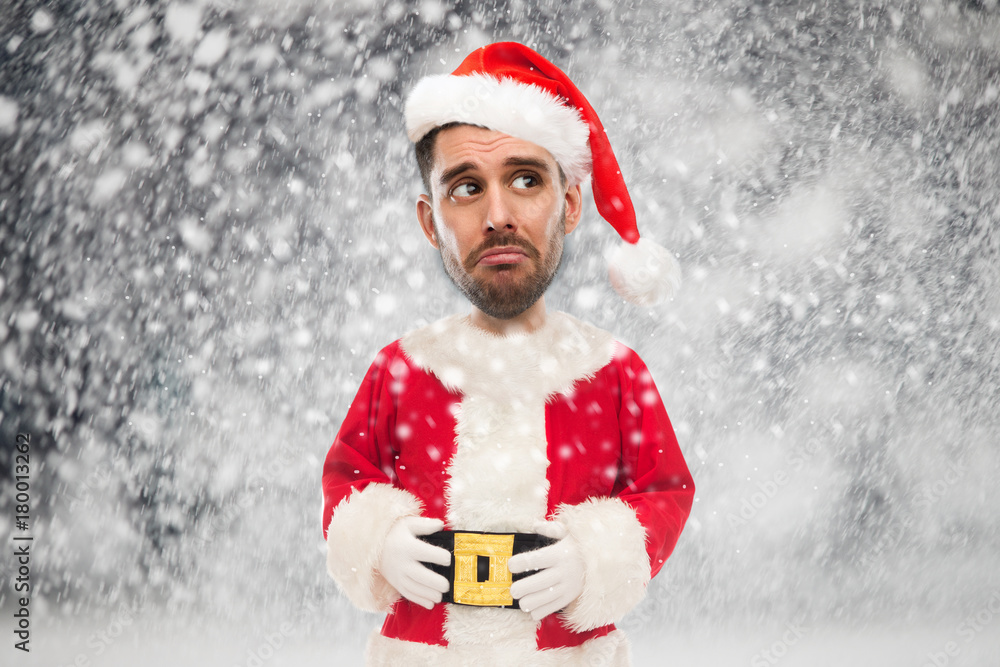 sad man in santa claus costume over christmas snow sad man in santa claus costume over christmas snow