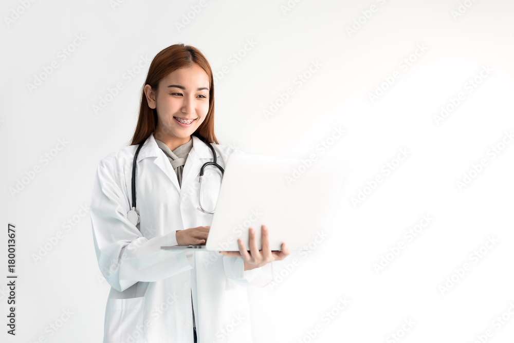 Female doctor using laptop with stethoscope on white background. Medical and Healthcare concept. People and Technology theme Female doctor using laptop with stethoscope on white background. Medical and Healthcare concept. People and Technology theme