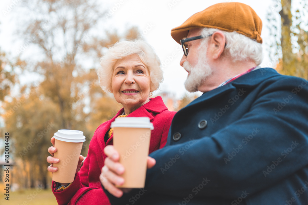 senior couple with coffee to go senior couple with coffee to go