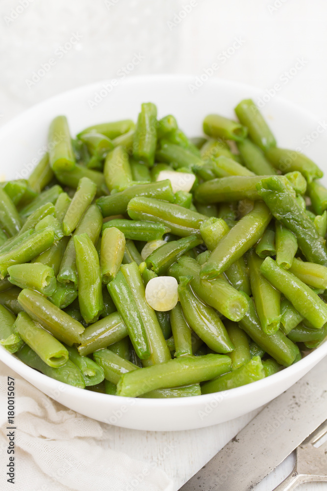 boiled green beans with garlic in white bowl boiled green beans with garlic in white bowl