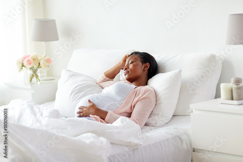 pregnant african american woman sleeping at home