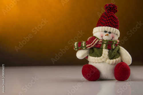 Pupazzo di neve con decorazioni di Natale sullo sfondo - sfondo color senape