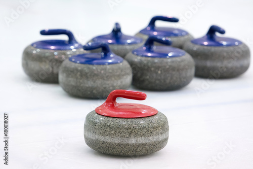 Curling group stone. Red stone and background blue stone
