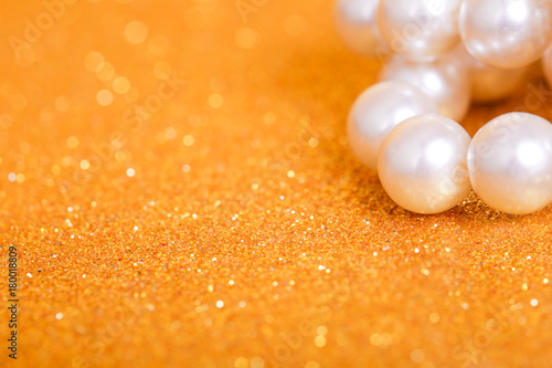 Pile of pearls on golden christmas background