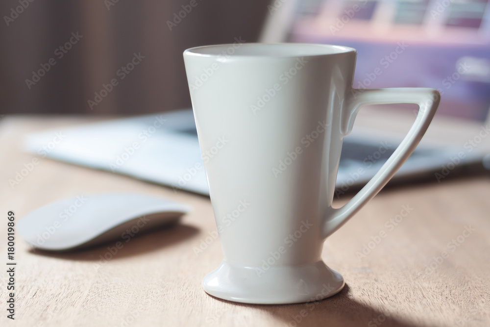 White mug on the desktop White mug on the desktop