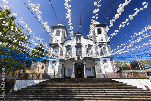 Blue and White decorative flowers strung up at the Church of Lady of Monte in the summertime in Funchal, Portugal.