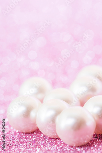Pile of pearls on pink festive background 