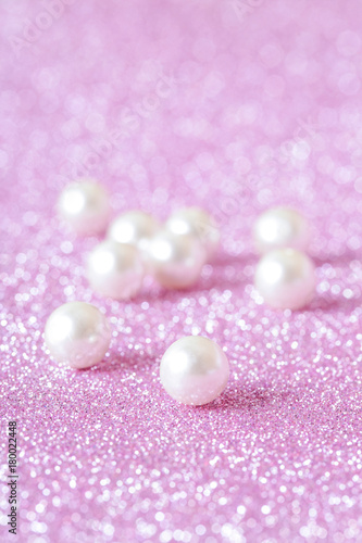 Pile of pearls on pink festive background 