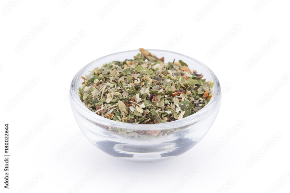 Ground italian herbs in glass bowl isolated on white background Ground italian herbs in glass bowl isolated on white background