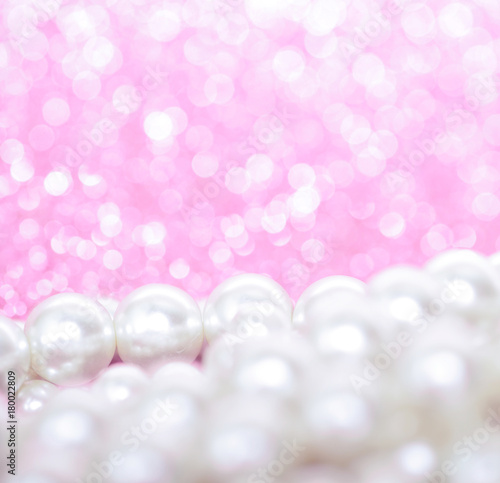 Pile of pearls on pink festive background
