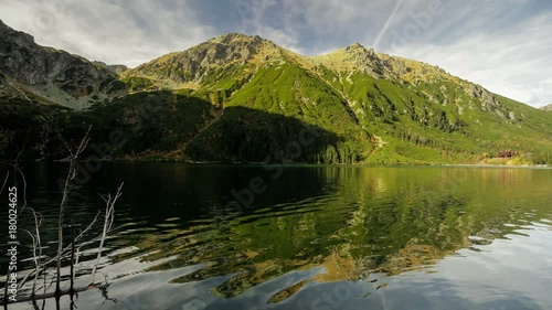 Time lapse reflection of clouds and shadow monsters in lake Morskie Oko, Tatra mountains, Poland landscape background timelapse