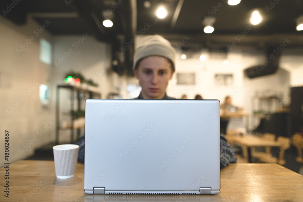 The freelancer works for a laptop in a cozy cafe. A student uses a laptop in a cafe. Focus on the laptop. The freelancer works for a laptop in a cozy cafe. A student uses a laptop in a cafe. Focus on the laptop.