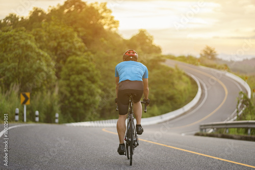 Fototapeta Naklejka Na Ścianę i Meble -  Cycling competition,cyclist athletes riding a race at high speed on mountain road, Sportsmen bikes in the morning,back view,vintage color,selective focus, sports concept,copy space