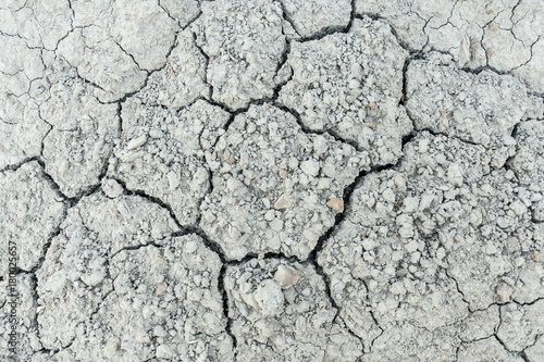 Severely dried cracked earth the concept of global drought, natural disasters, environmental problems, drought very closeup with gravel