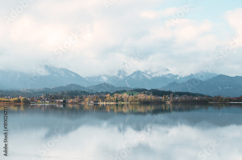 Serenity morning on Alpine mountains lake with reflection. Forggensee, Germany, Europe