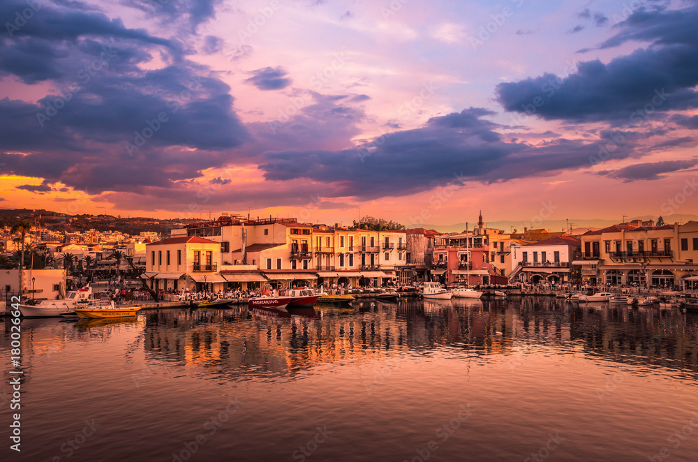 RETHYMNO, CRETE ISLAND, GREECE – JUNE 29, 2016: View of the old venetian port of Rethimno at sunset.