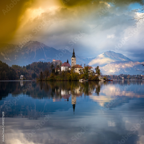 Bled  Slovenia - Beautiful autumn sunrise at Lake Bled with the famous Pilgrimage Church of the Assumption of Maria with Bled Castle and Julian Alps at background