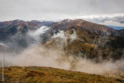 View from the peak of Kasprowy Wierch on the misty mountain massif Czerwone Wierchy in Tatra mountains, Poland