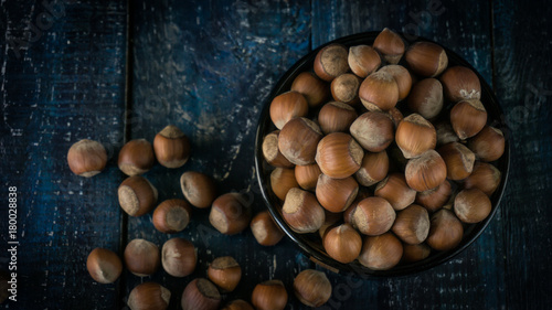 Group of hazelnuts on wooden rustic background