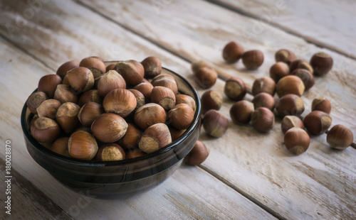 Group of hazelnuts on wooden rustic background